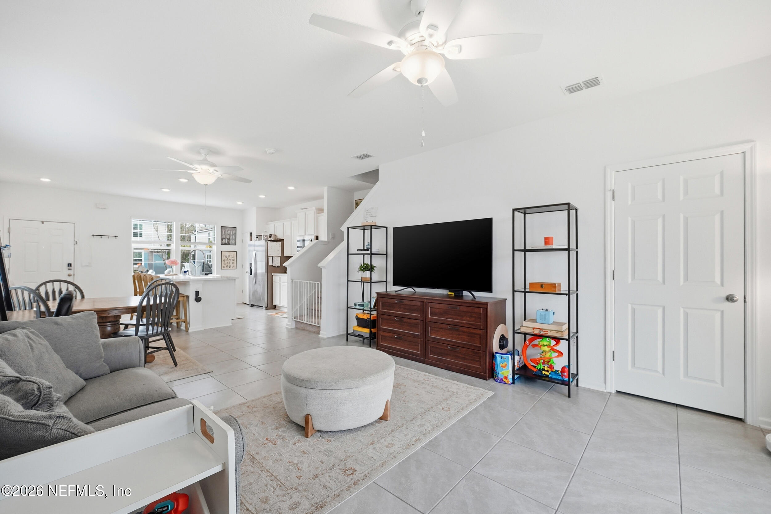 8323 Asteroid Street Jacksonville, FL 32256 - Photo 8 of 27 a living room with furniture and a flat screen tv