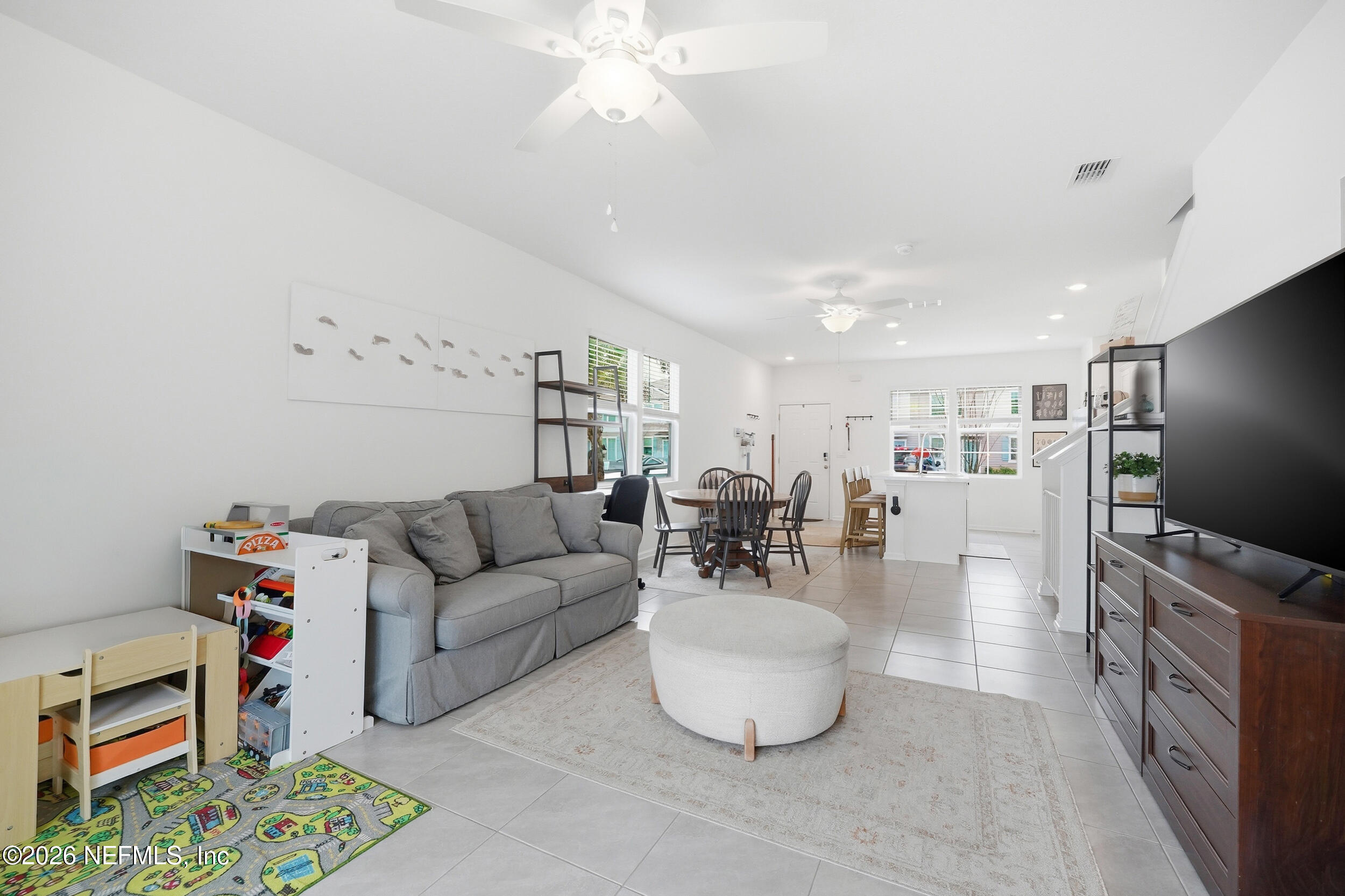 8323 Asteroid Street Jacksonville, FL 32256 - Photo 10 of 27 a living room with furniture and a flat screen tv