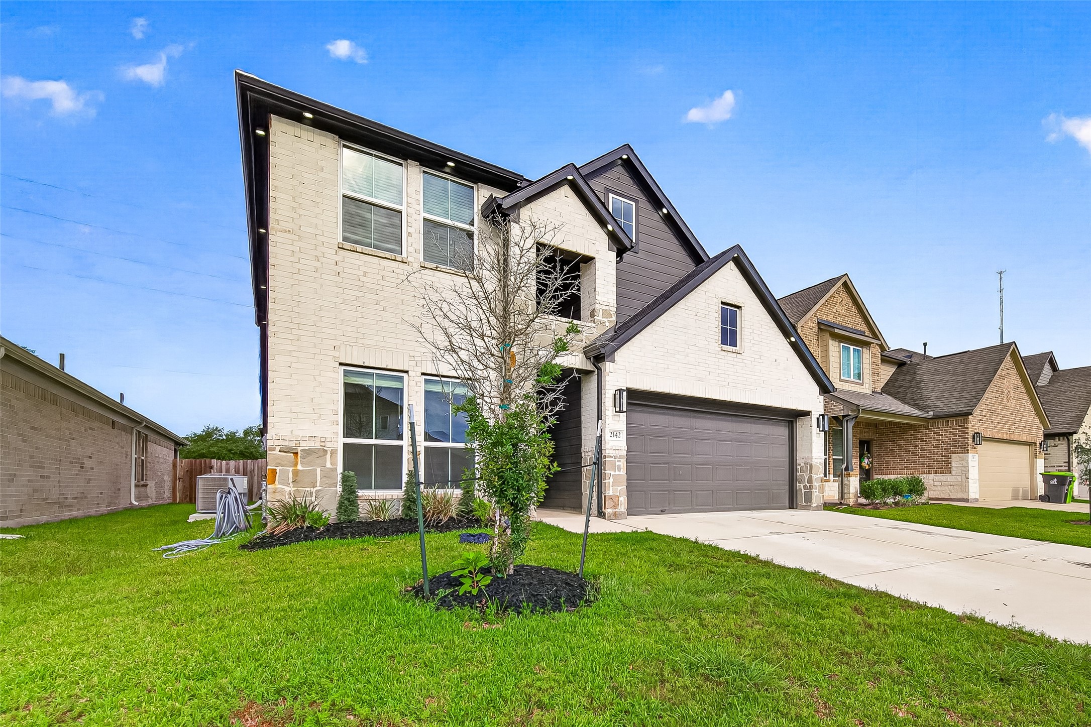 2142 Reed Cave Lane Spring, TX 77386 - Photo 2 of 50 a front view of a house with a yard and garage