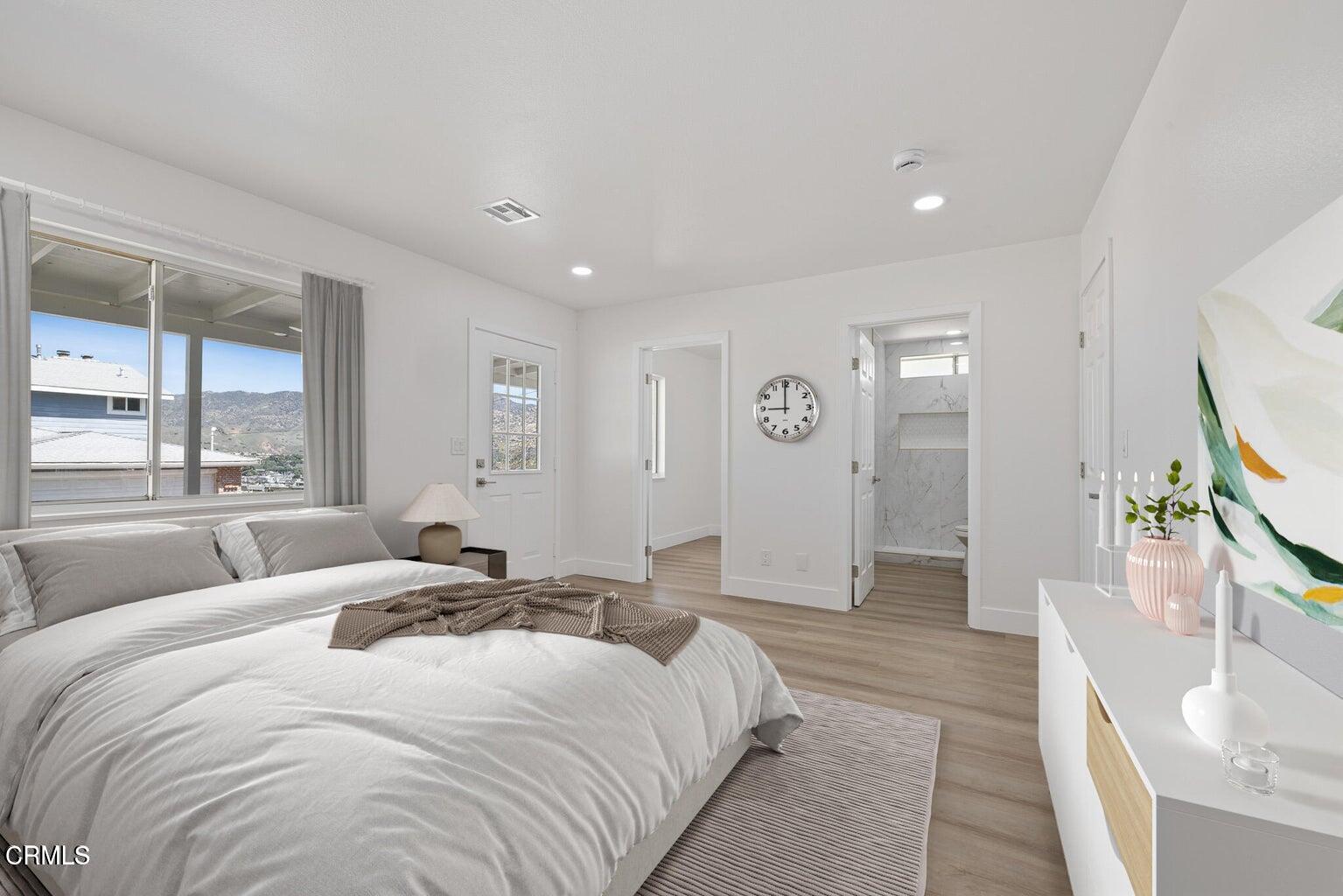 6015 Peppertree Lane Simi Valley, CA 93063 - Photo 12 of 15 a spacious bedroom with a large bed and a flat screen tv