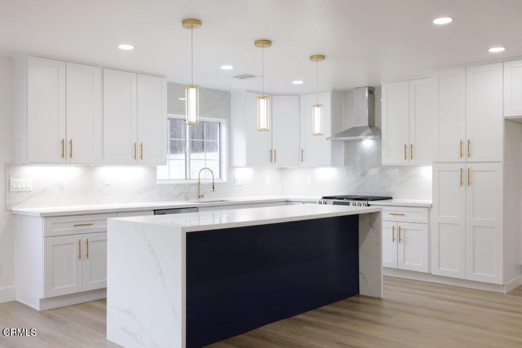6015 Peppertree Lane Simi Valley, CA 93063 - Photo 4 of 15 a kitchen with stainless steel appliances granite countertop a sink stove and refrigerator