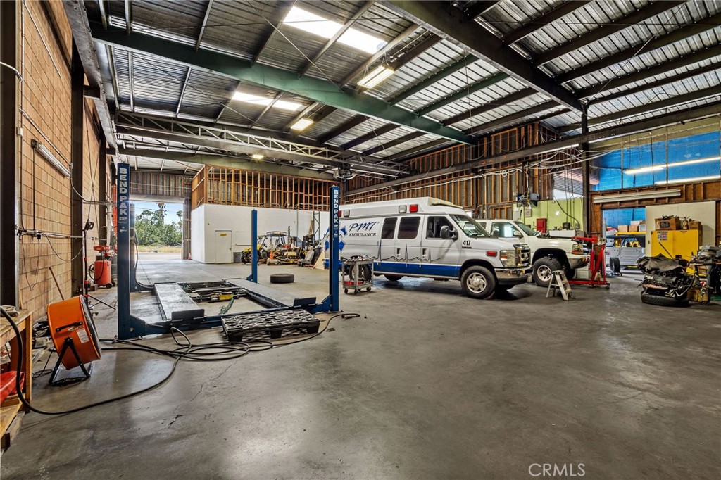 484 East Redlands Boulevard San Bernardino, CA 92408 - Photo 11 of 27 a view of a garage with cars and a bike