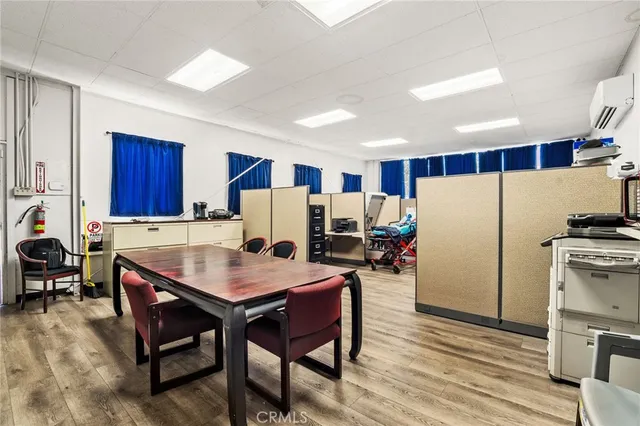 a kitchen with a table chairs refrigerator and cabinets