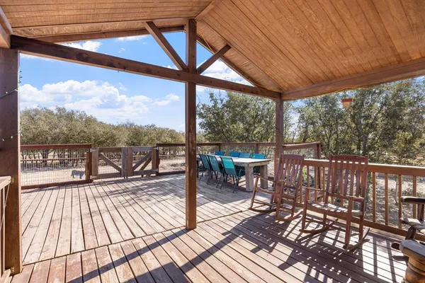 a view of a balcony with chairs and wooden floor