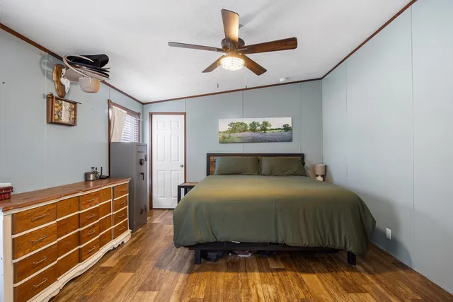 a bedroom with a bed and a ceiling fan