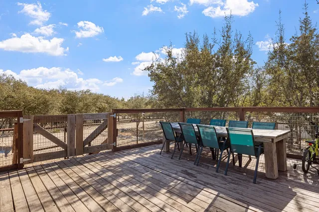 a view of a roof deck with table and chairs