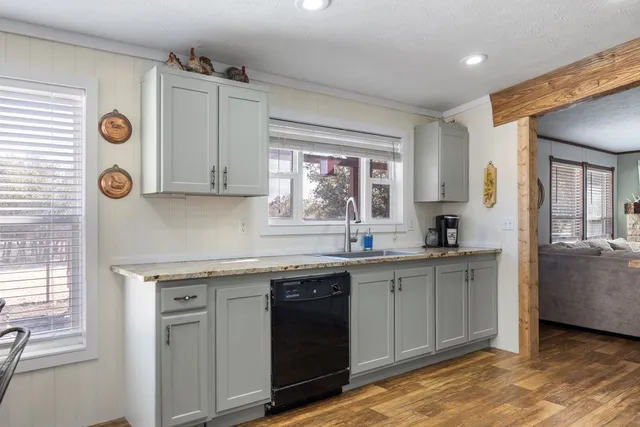 a kitchen with a sink and a stove top oven
