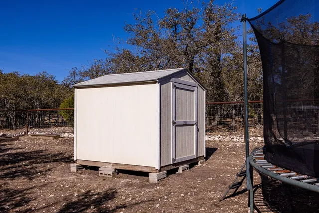 a view of backyard with barn and a cactus plant