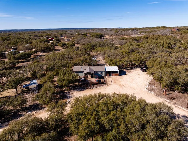 an aerial view of a house with a yard