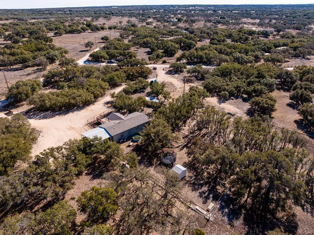 an aerial view of a houses with a yard