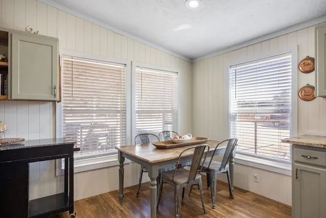 a view of a dining room with furniture and window