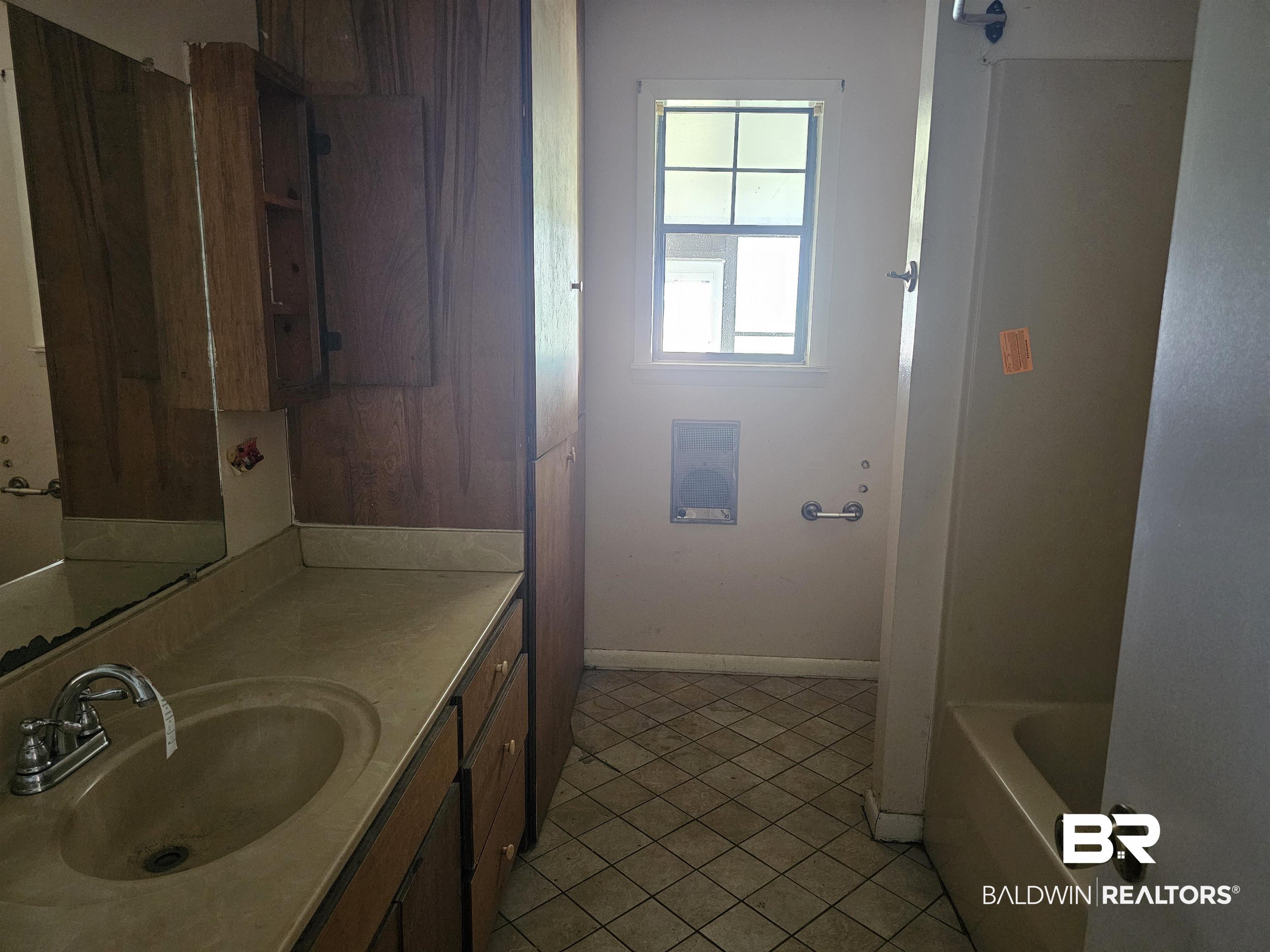 59575 Lottie Road Atmore, AL 36502 - Photo 22 of 23 Bathroom with vanity, baseboards, a tub, and tile patterned floors