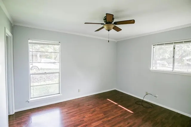 a view of a room with wooden floor and windows