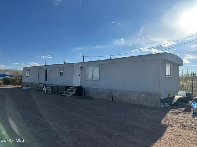 a view of a patio with table and chairs