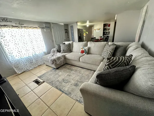 a living room with furniture and a large window
