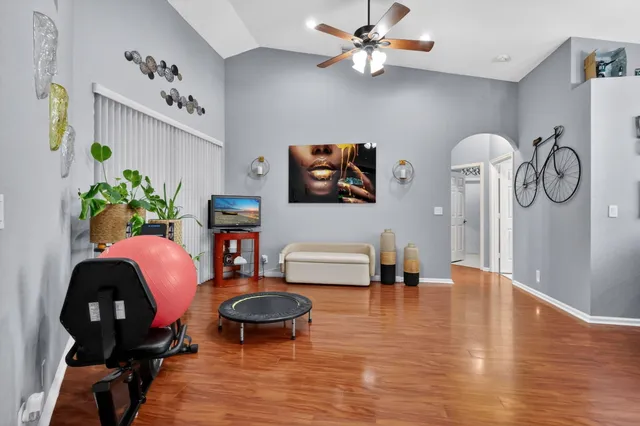 a living room with furniture and wooden floor