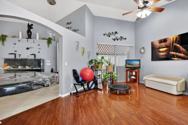 a living room with furniture and a wooden floor