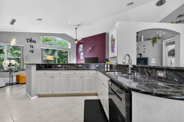 a large kitchen with a sink and cabinets