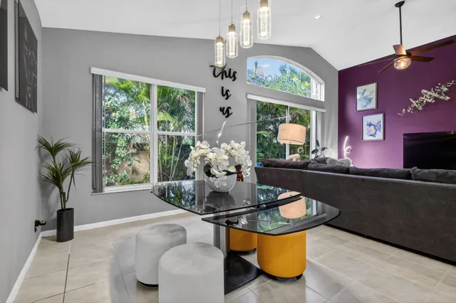 a living room with furniture a window and a chandelier