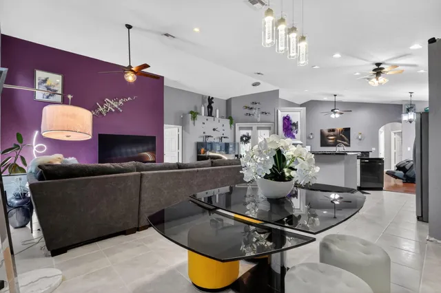 a kitchen with a chandelier and living room