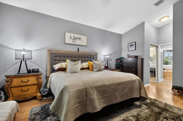 a bedroom with a bed and wooden floor