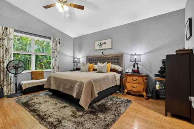 a bedroom with a bed a couch and a chandelier