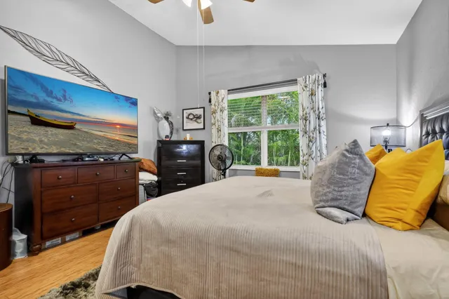 a bedroom with a bed and a window