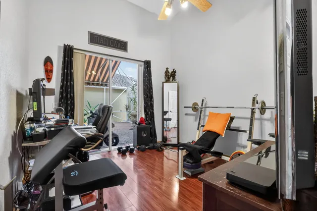 a view of a workspace with furniture and floor to ceiling window