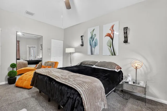 a bedroom with two bed and a painting on the wall