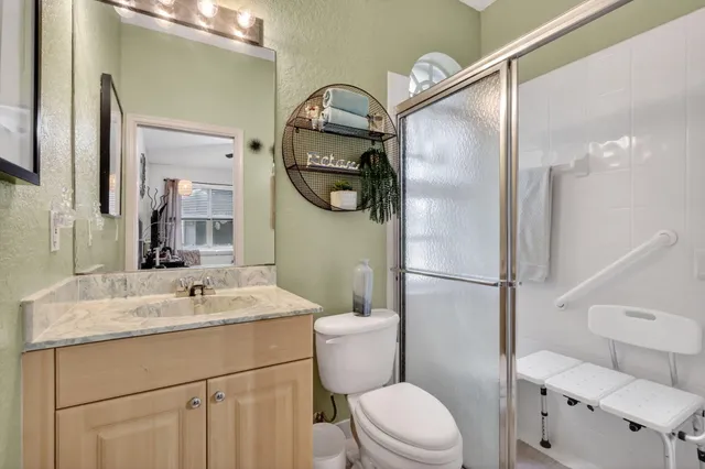 a bathroom with a sink a toilet and a mirror