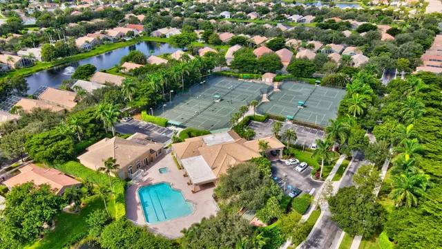 an aerial view of a house with a garden and swimming pool