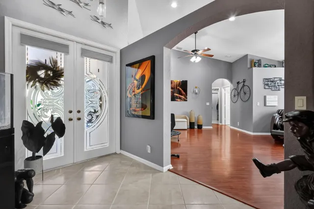 a view of a livingroom with furniture hardwood floor and a ceiling fan