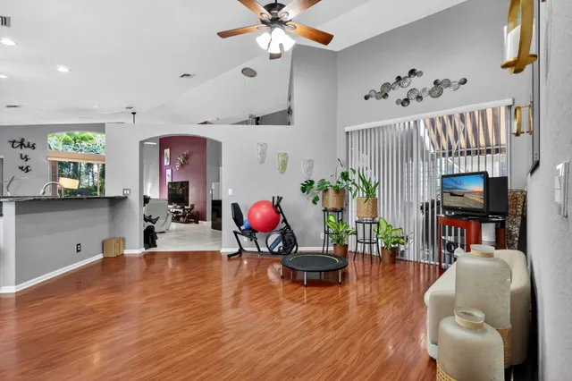 a living room with furniture and a wooden floor