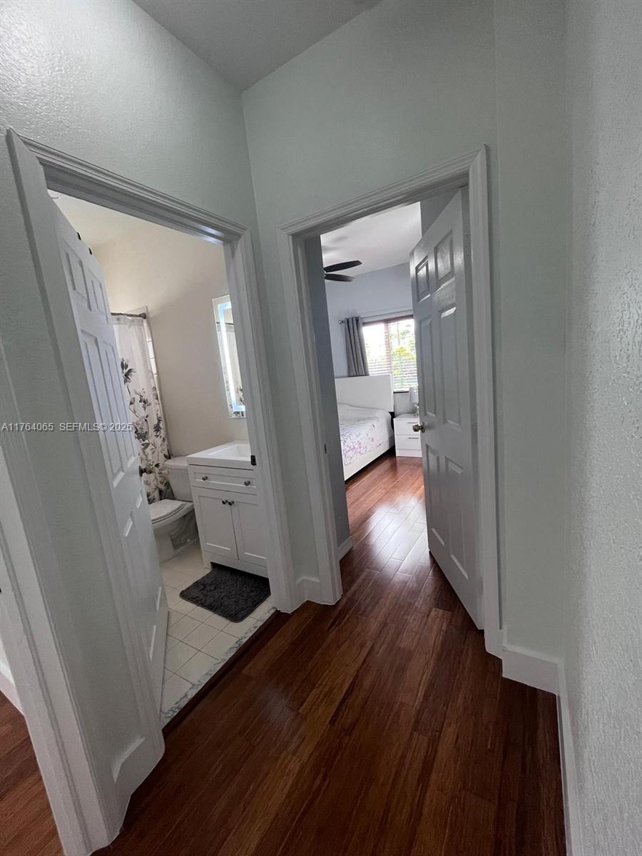 22937 Southwest 9th Avenue, Unit 1 Miami, FL 33170 - Photo 15 of 19 a view of a hallway with wooden floor and a living room