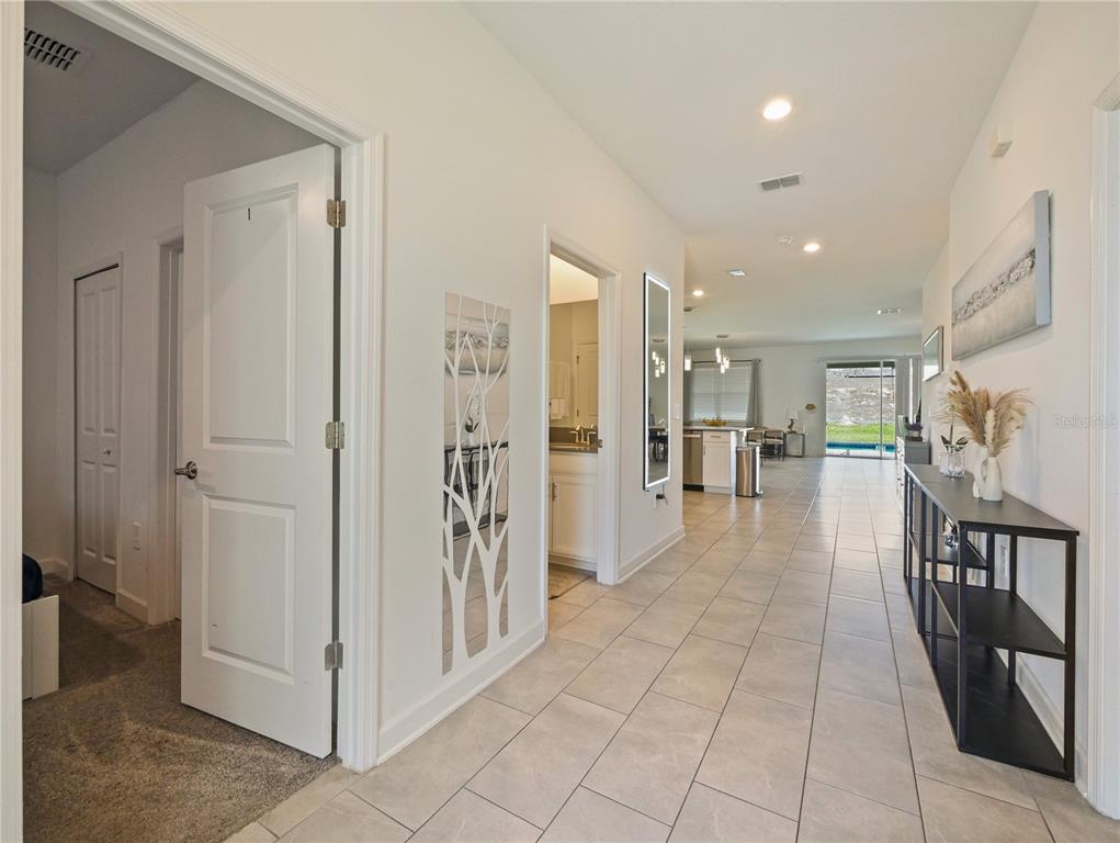 9084 Sommerset Hills Drive Davenport, FL 33896 - Photo 14 of 63 a view of a hallway with dining area