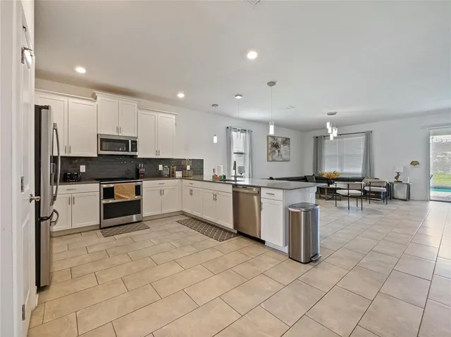 a view of a dining room with furniture and chandelier