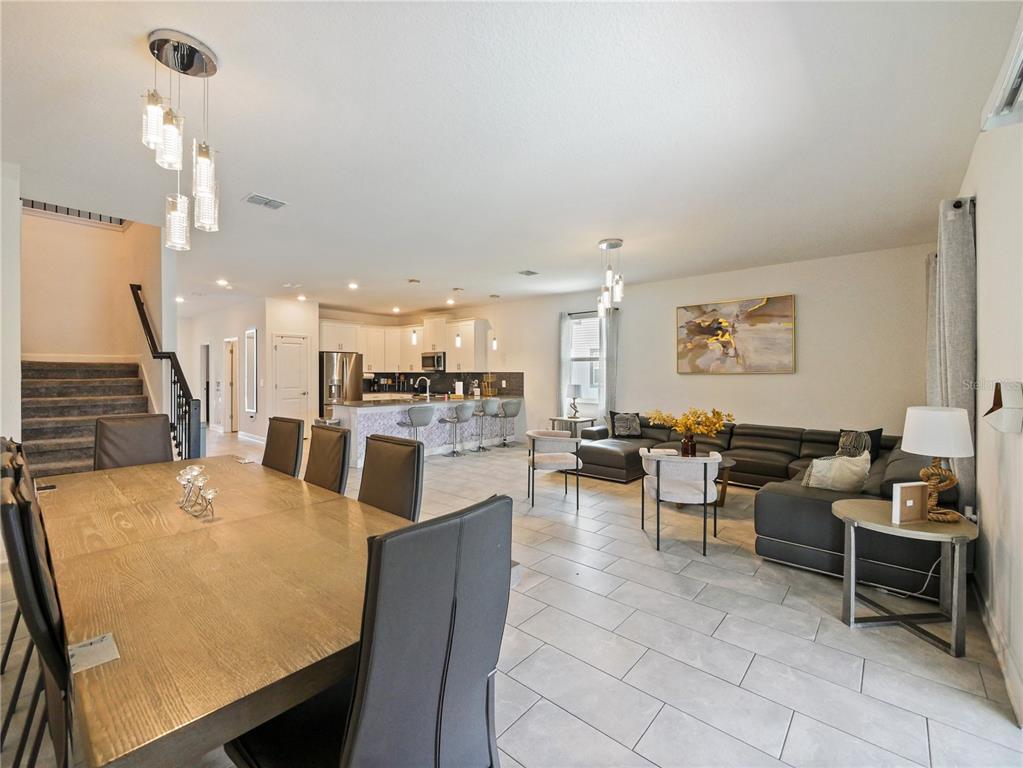 9084 Sommerset Hills Drive Davenport, FL 33896 - Photo 23 of 63 a living room with lots of furniture and kitchen view