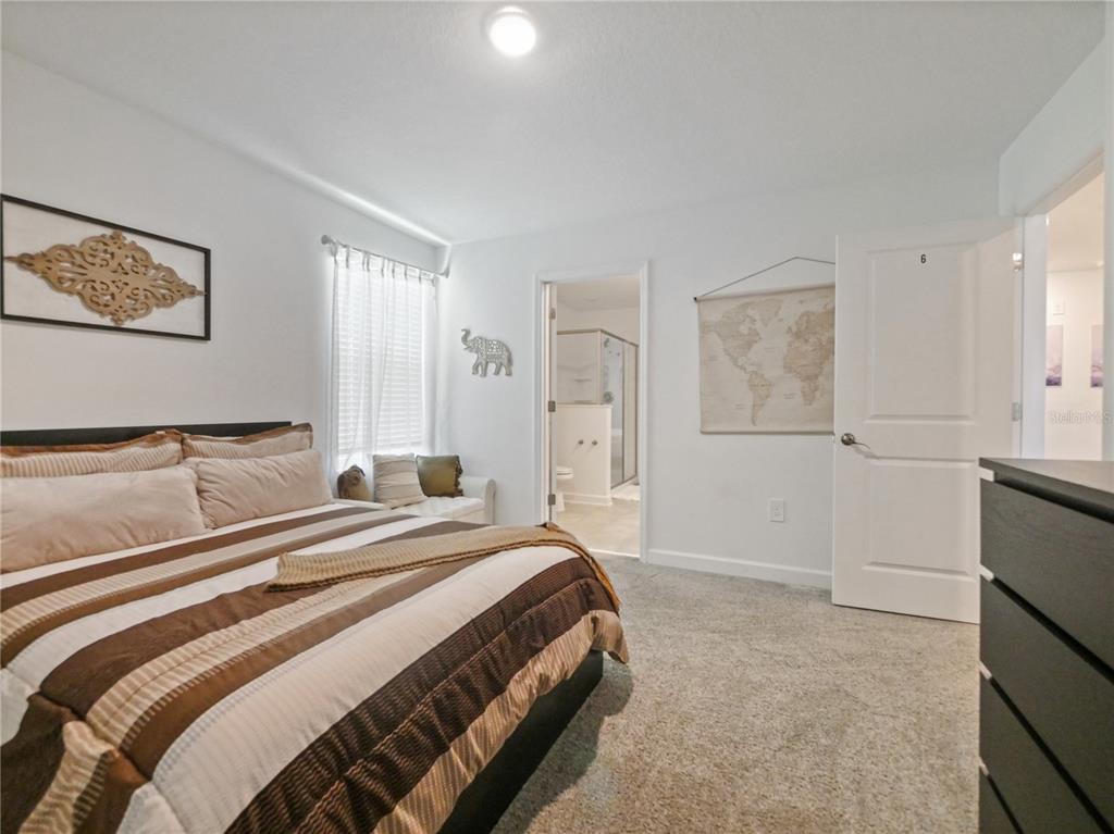 9084 Sommerset Hills Drive Davenport, FL 33896 - Photo 29 of 63 a bedroom with a bed and a cabinets