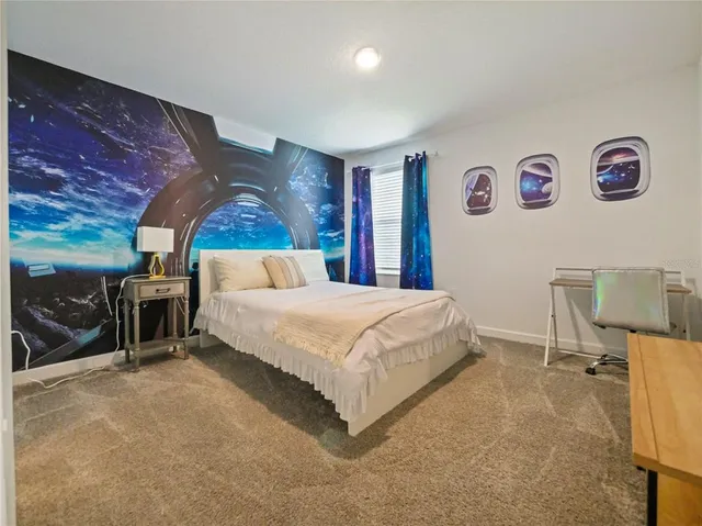 a spacious bedroom with a bed and a window