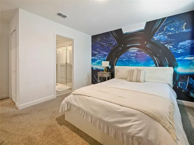 a bedroom with a bed and a cabinets