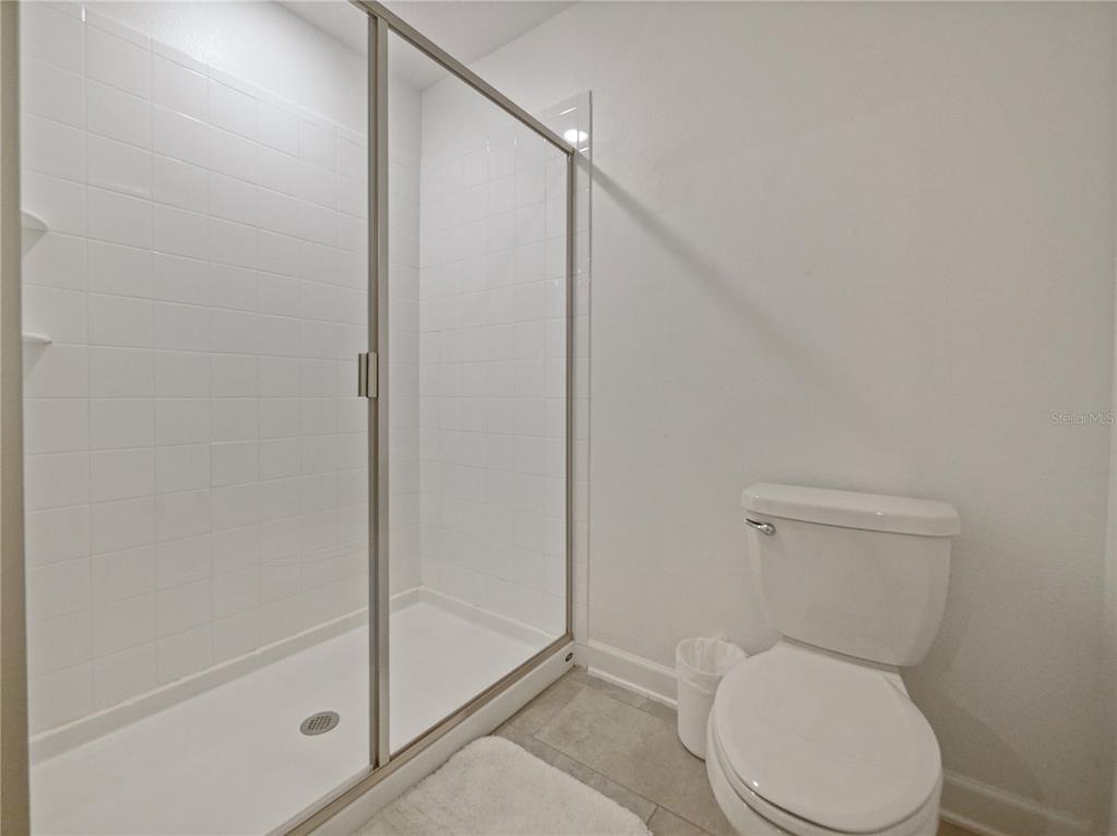 9084 Sommerset Hills Drive Davenport, FL 33896 - Photo 35 of 63 a white toilet sitting next to a shower