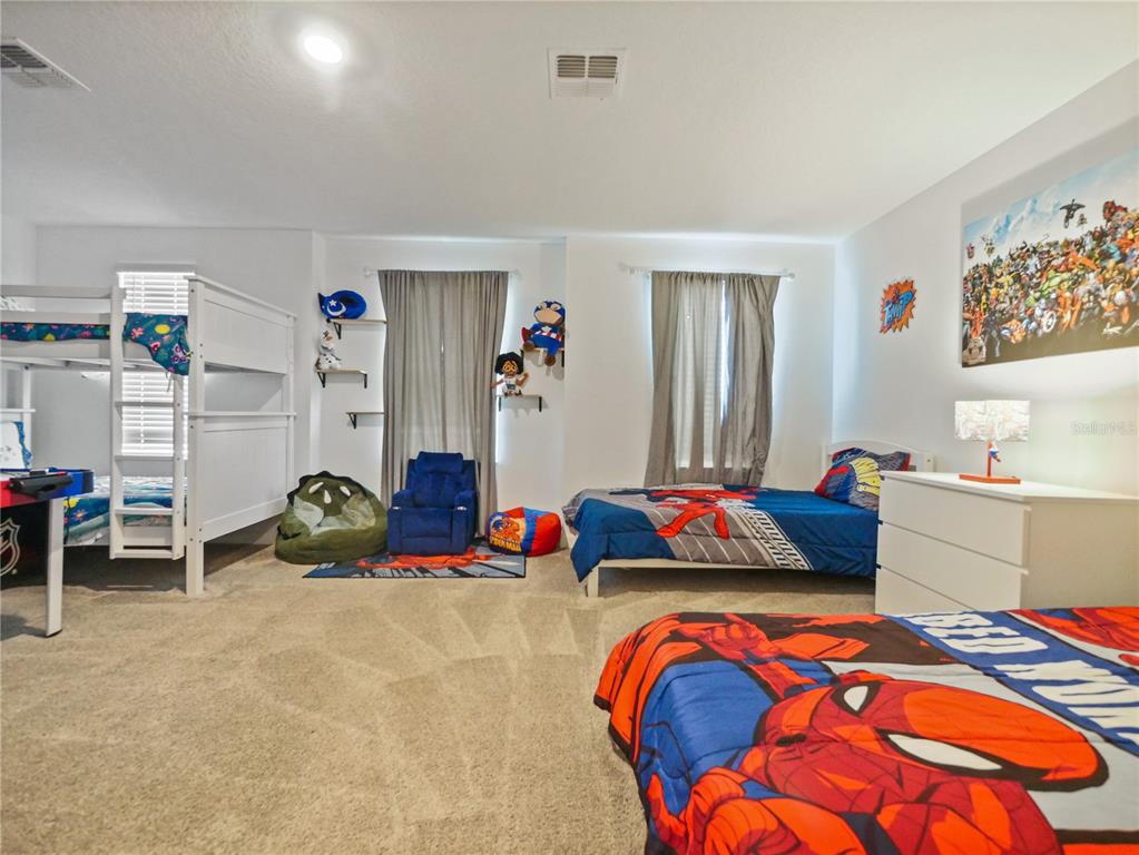 9084 Sommerset Hills Drive Davenport, FL 33896 - Photo 37 of 63 a bedroom with two beds and a couch