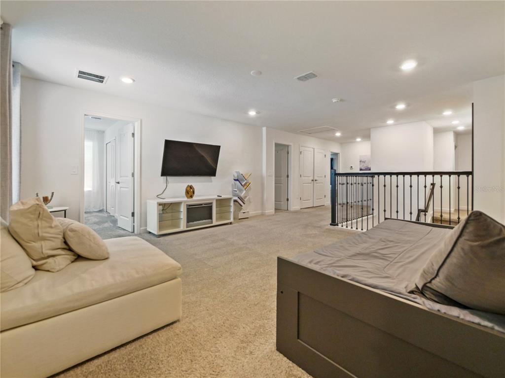9084 Sommerset Hills Drive Davenport, FL 33896 - Photo 40 of 63 a living room with furniture and a flat screen tv