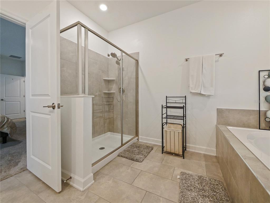 9084 Sommerset Hills Drive Davenport, FL 33896 - Photo 44 of 63 a bathroom with a shower and a sink