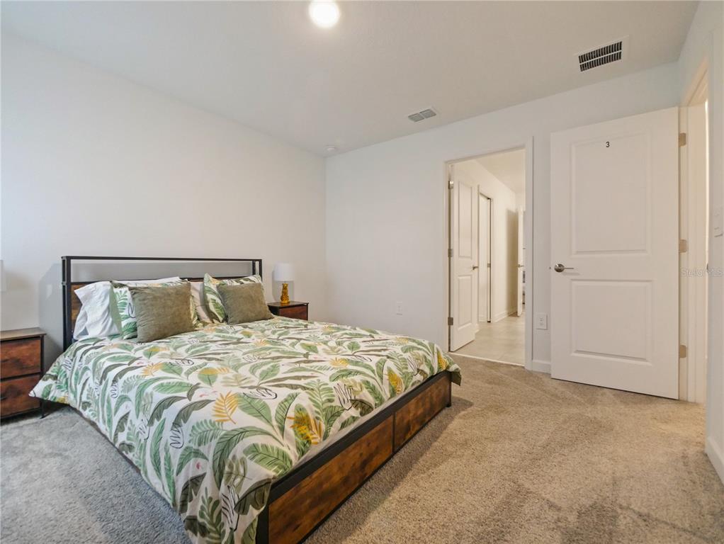 9084 Sommerset Hills Drive Davenport, FL 33896 - Photo 49 of 63 a bedroom with a bed and closet