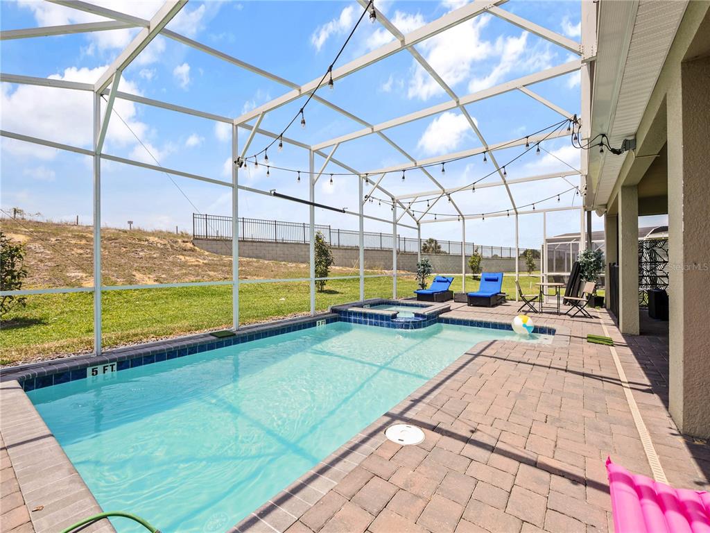 9084 Sommerset Hills Drive Davenport, FL 33896 - Photo 55 of 63 a view of a swimming pool with a porch