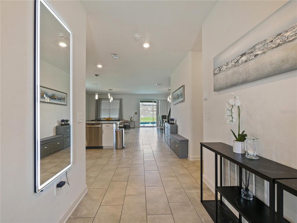 9084 Sommerset Hills Drive Davenport, FL 33896 - Photo 8 of 63 a lobby with furniture and floor to ceiling window