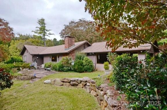 32 Locust Street Tryon, NC 28782 - Photo 1 of 1 a view of a house with a yard and garden