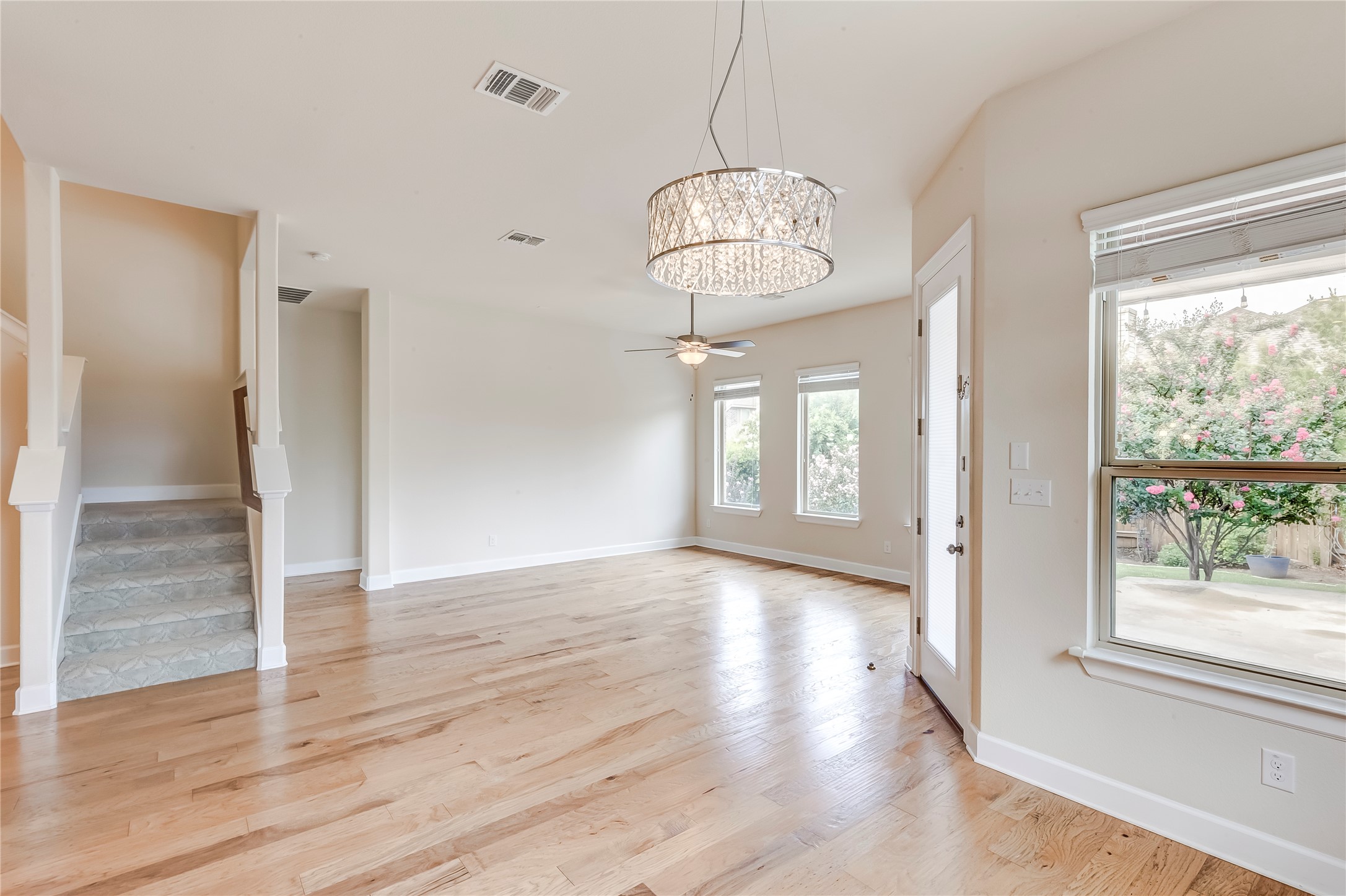 345 Fort Cobb Way Georgetown, TX 78628 - Photo 13 of 38 Polished hardwood flooring and a modern light fixture define this versatile living area.