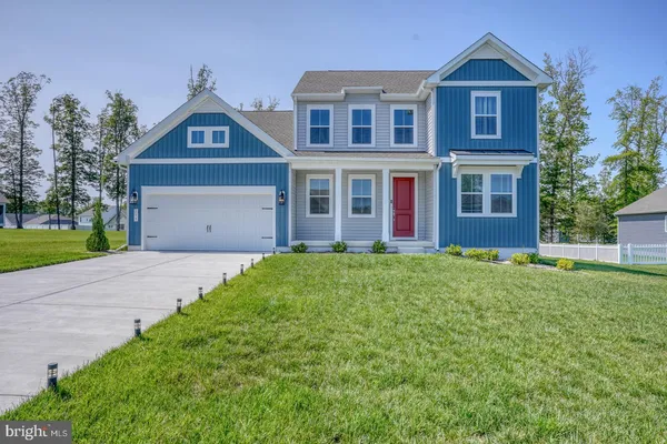 a view of a brick house with a yard and large windows